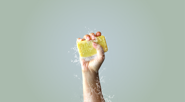 Womans hand holding lemon verbena marie ernst bar soap