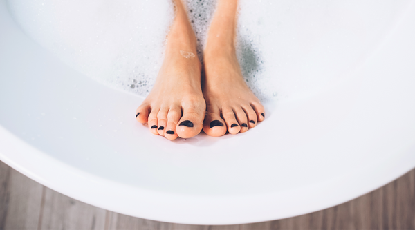 Womans feet in bathtub